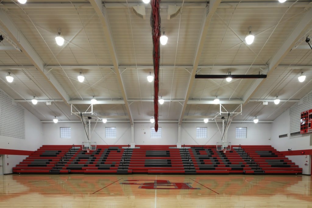 Basketball court with bleachers that say BC