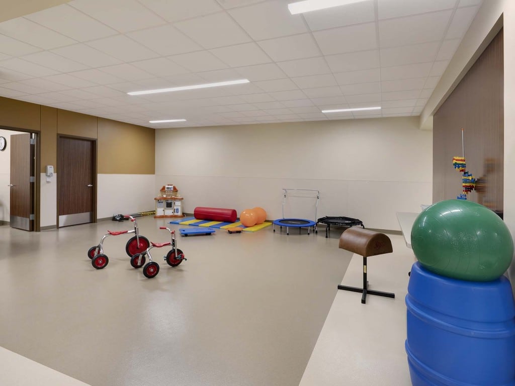 Children's rehabilitation center with trampolines, bikes, and additional equipment