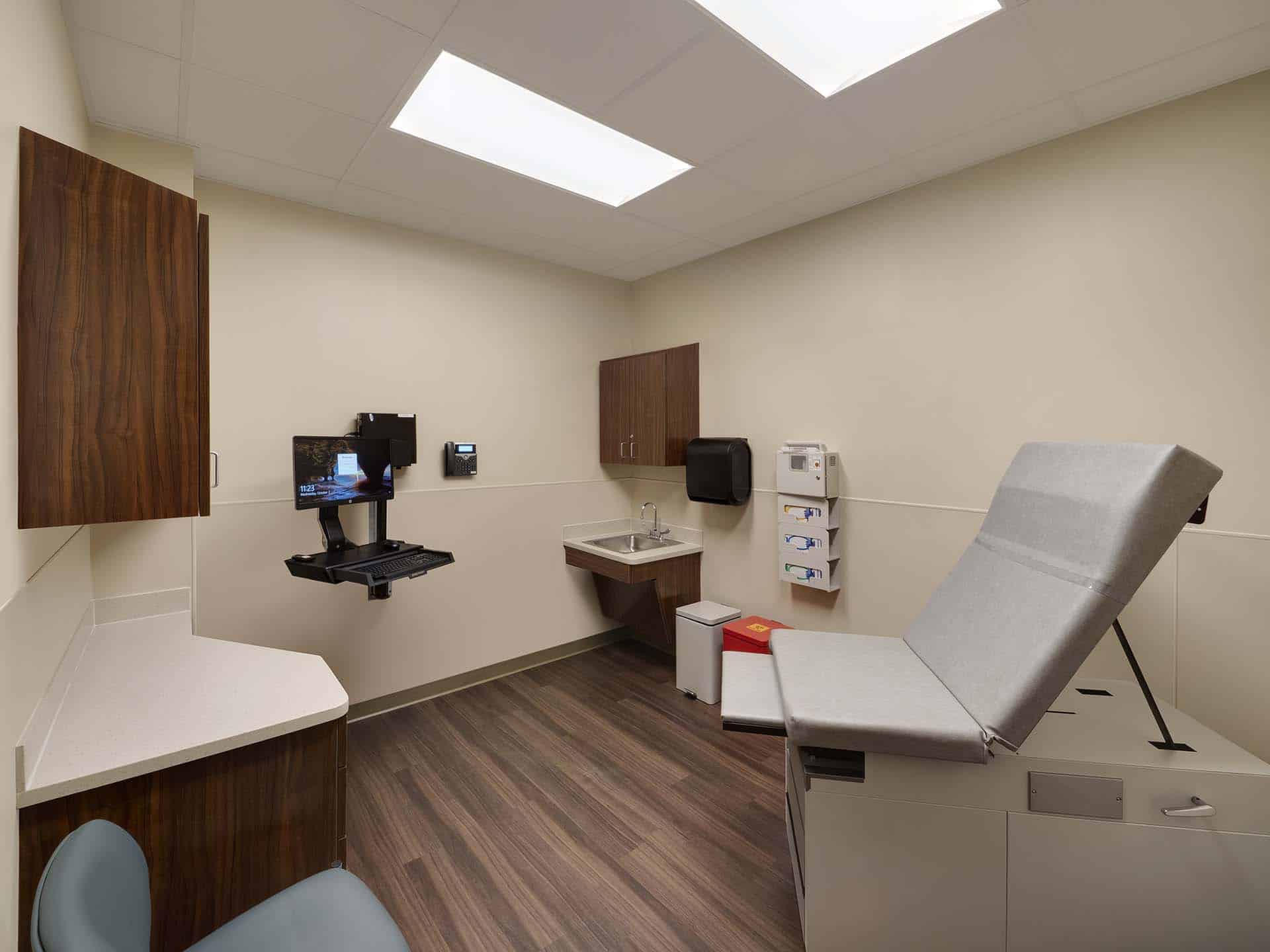 Patient room with exam table, sink and computer