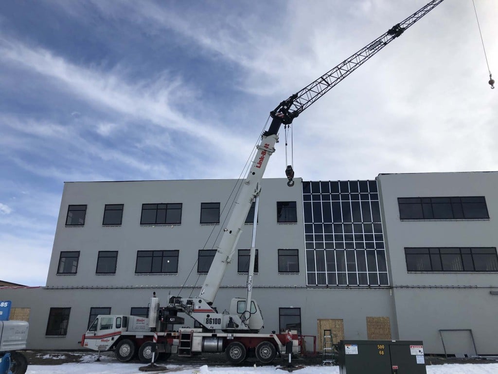 Boom crane over building under construction