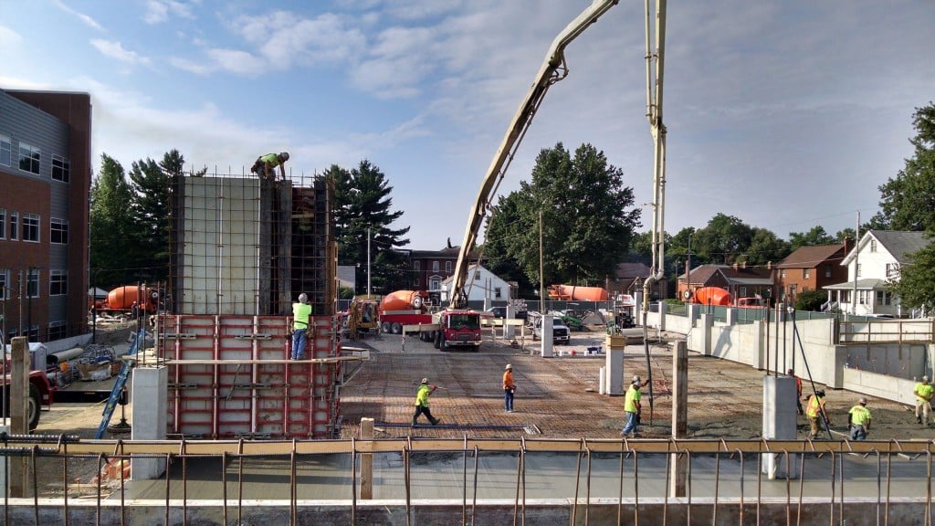 Concrete being poured at a building construction site.