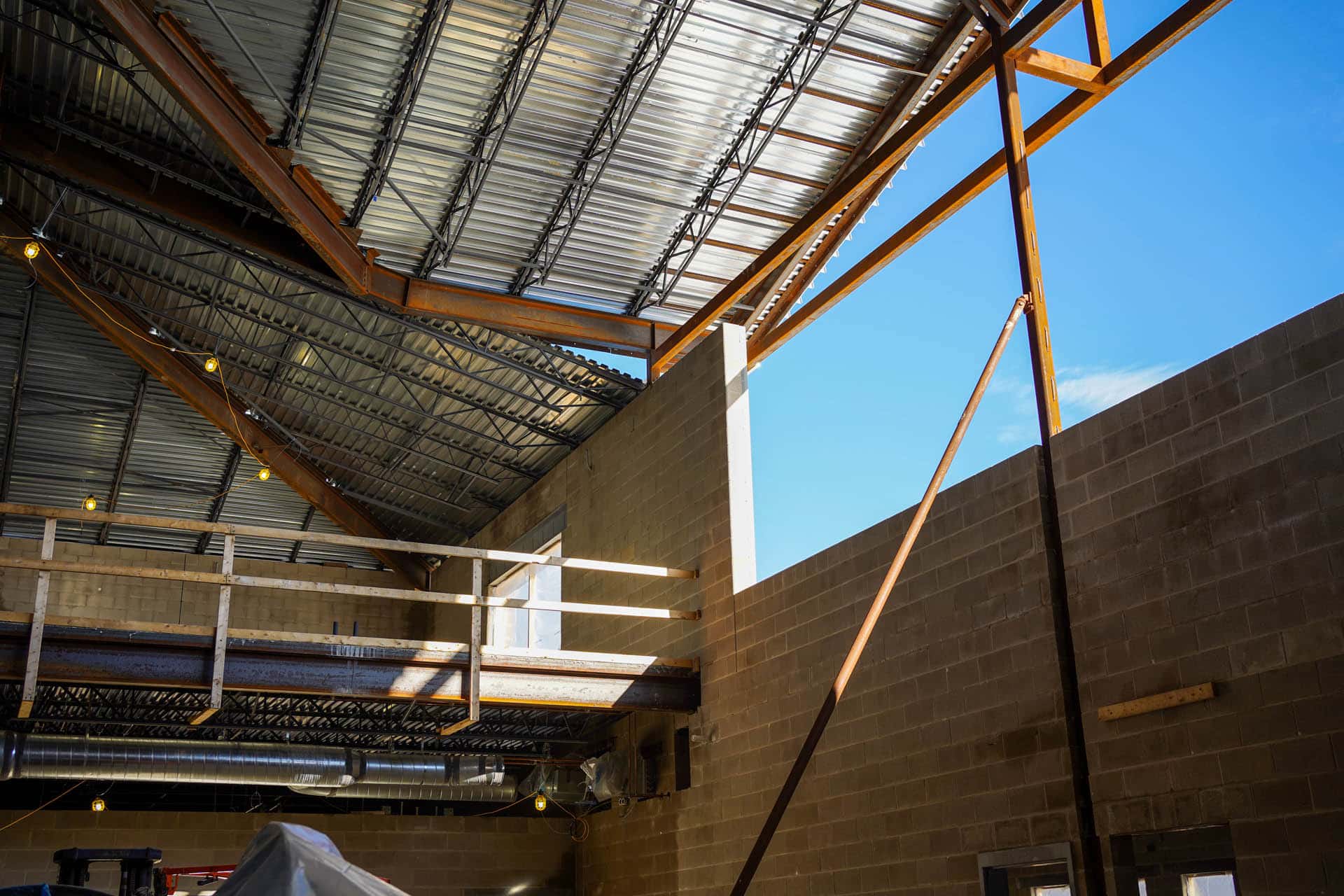 Interior of cement brick building with metal roofs under construction