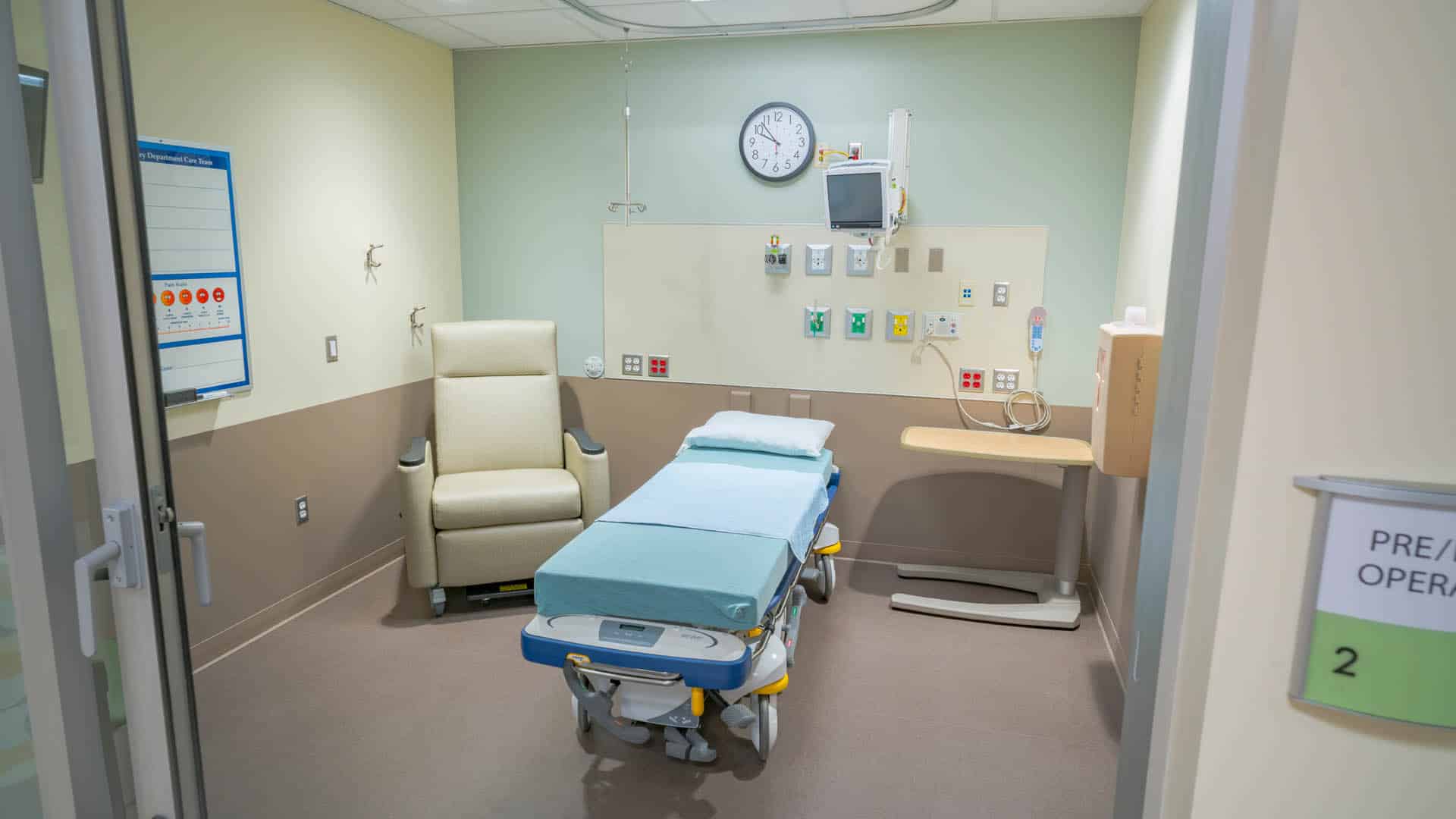 Patient room with hospital bed and chair
