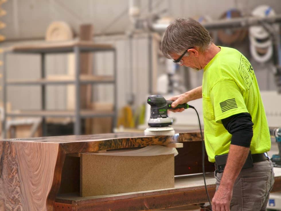 Person polishing wooden table